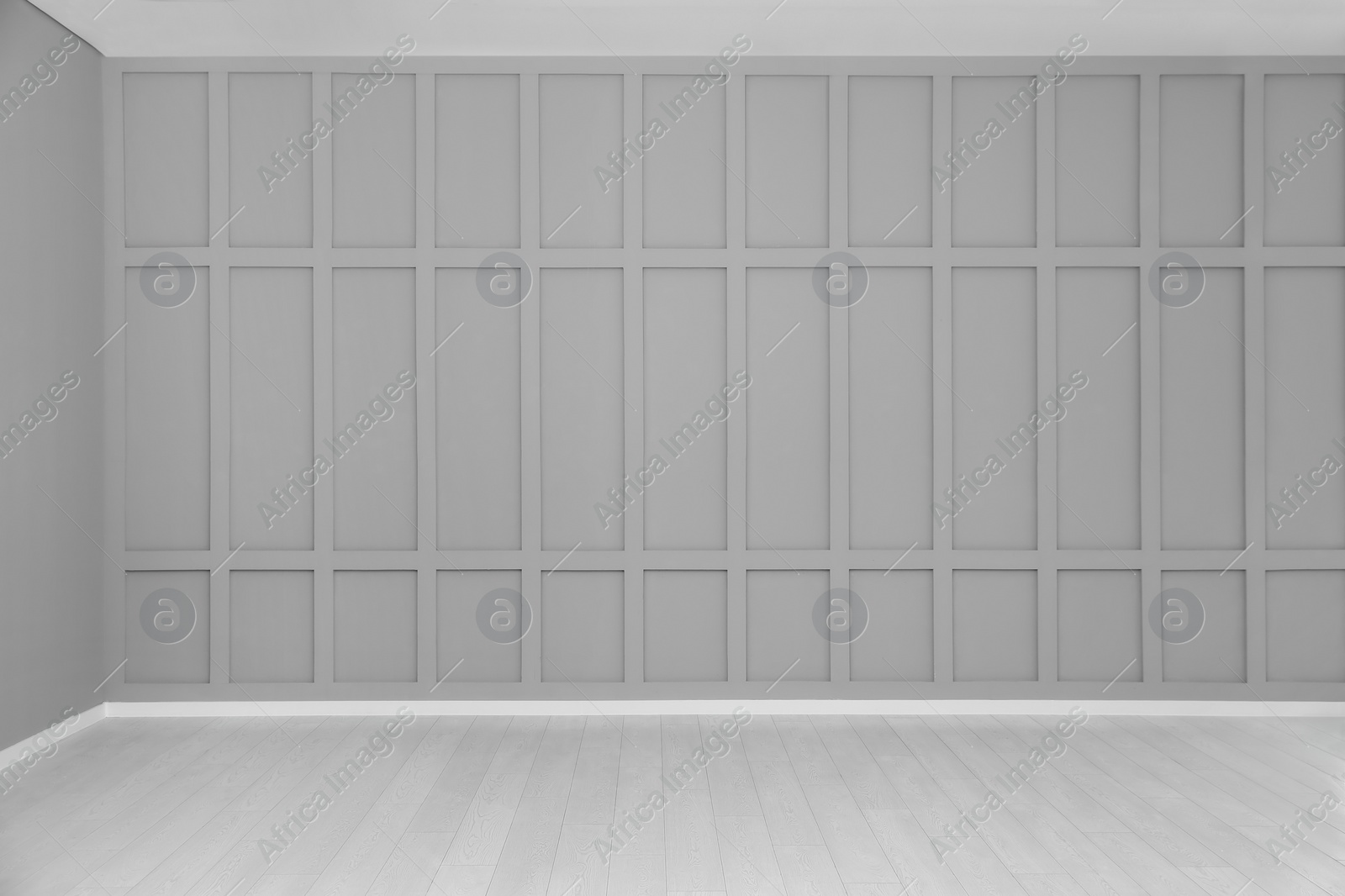 Photo of Empty room with grey wall and laminated floor