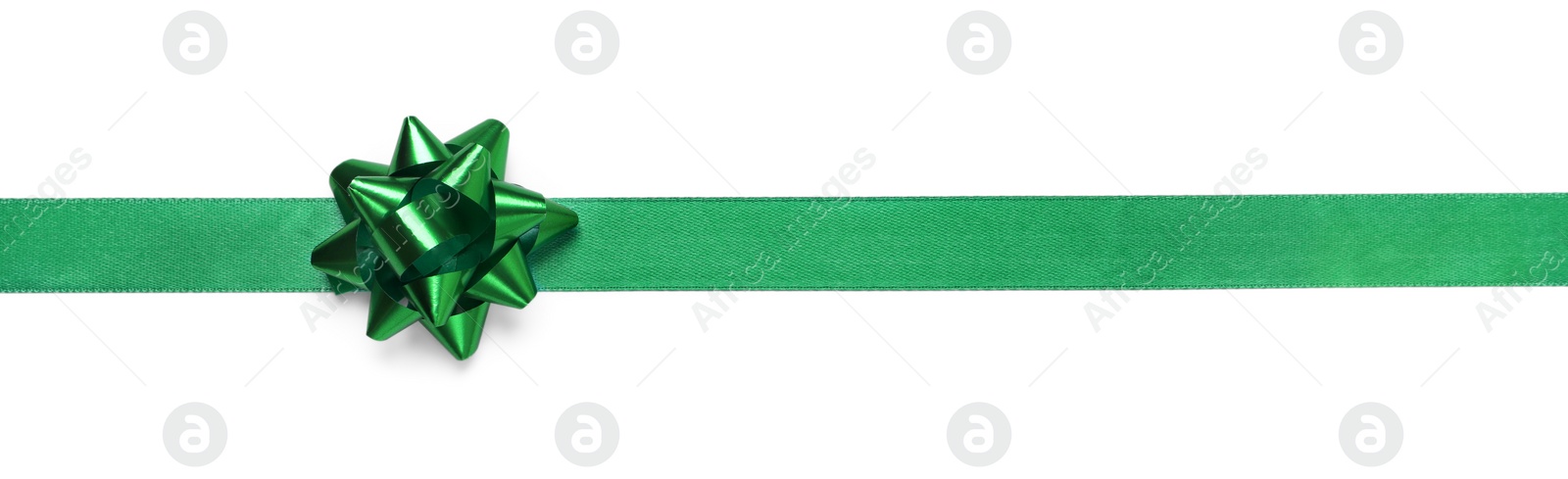 Photo of Green ribbon with bow on white background, top view