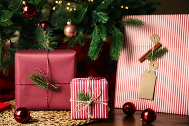 Photo of Composition with beautifully wrapped gift boxes on wooden table