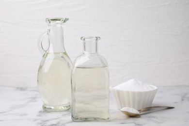 Vinegar and baking soda on white marble table