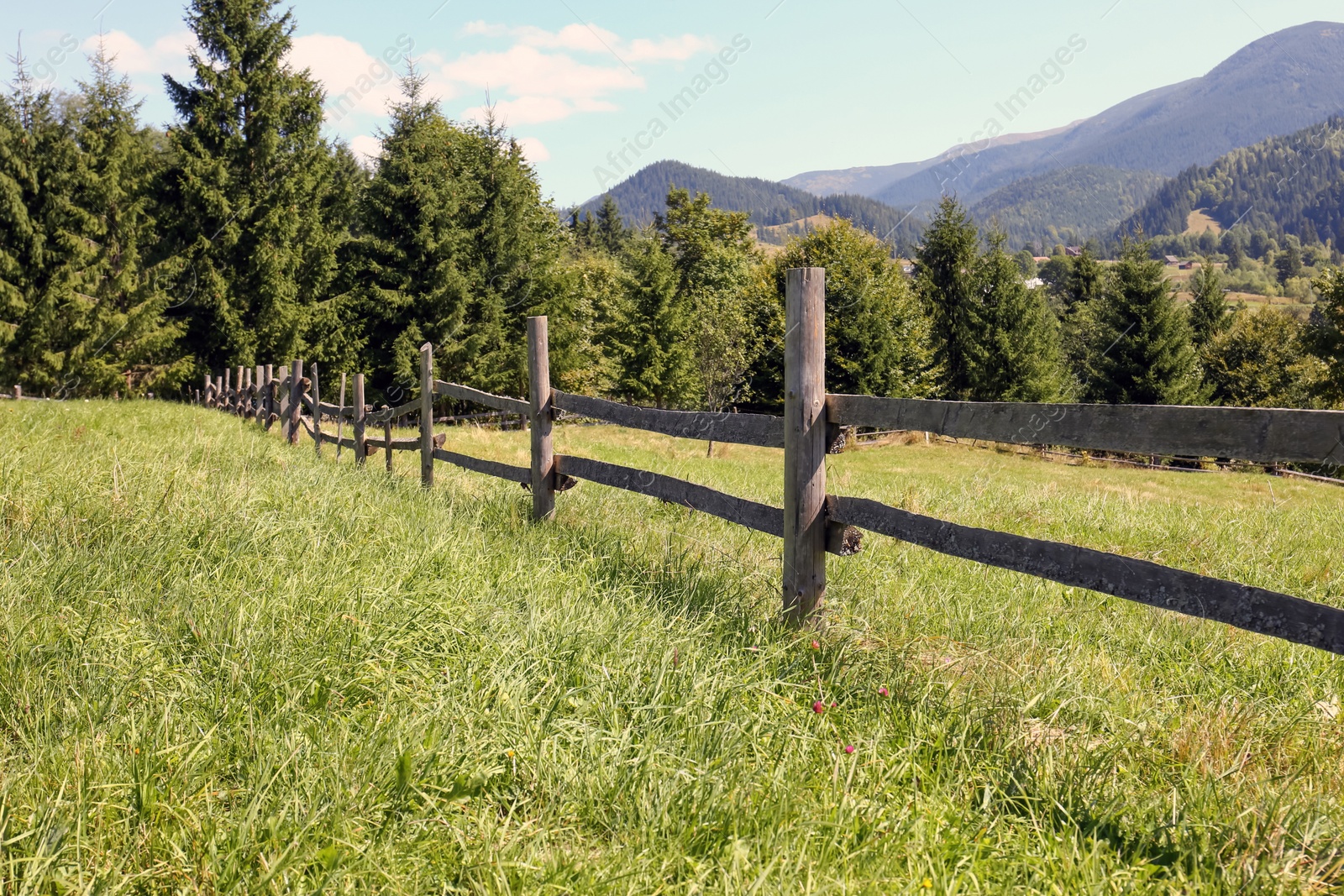 Photo of Beautiful view of mountain countryside with wooden fence