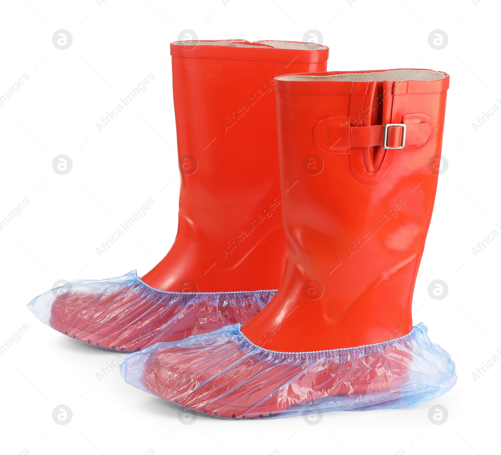 Photo of Rubber boots in blue shoe covers isolated on white