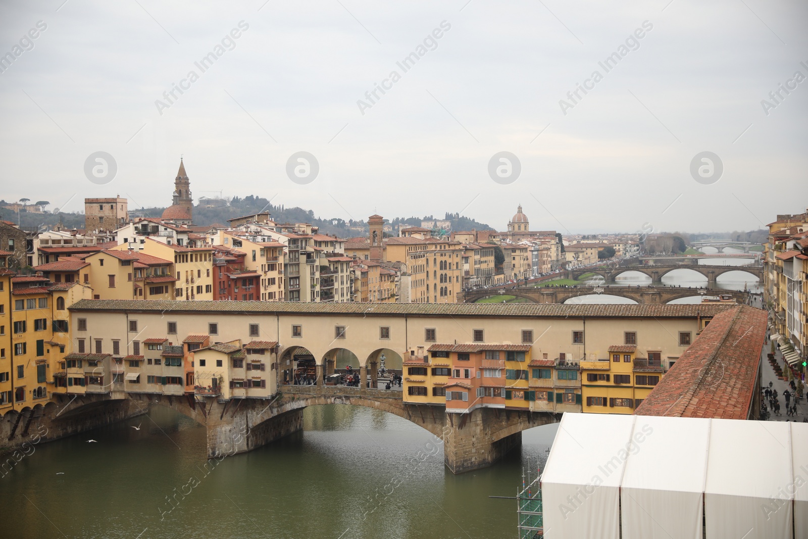 Photo of Florence, Italy - February 8, 2024: Picturesque view of city with beautiful buildings and river