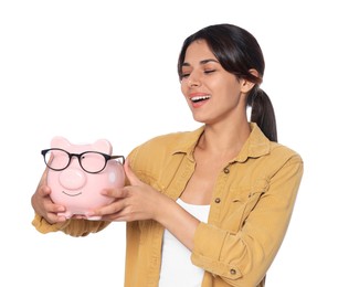 Photo of Young woman with piggy bank on white background