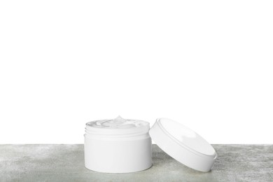 Photo of Jar of hand cream on gray table against white background