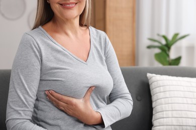 Photo of Woman doing breast self-examination at home, closeup. Space for text