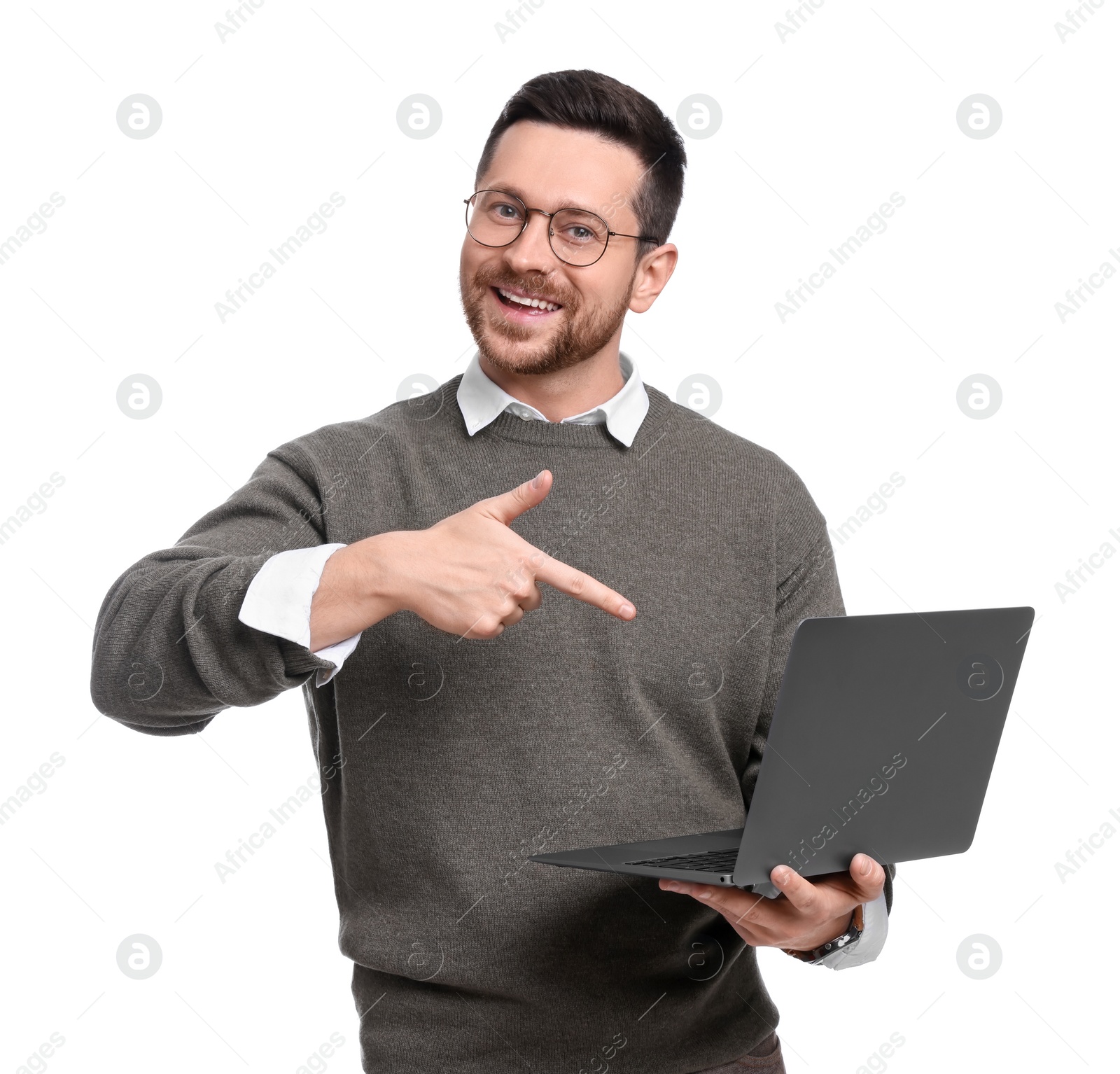 Photo of Handsome bearded businessman with laptop pointing at something on white background