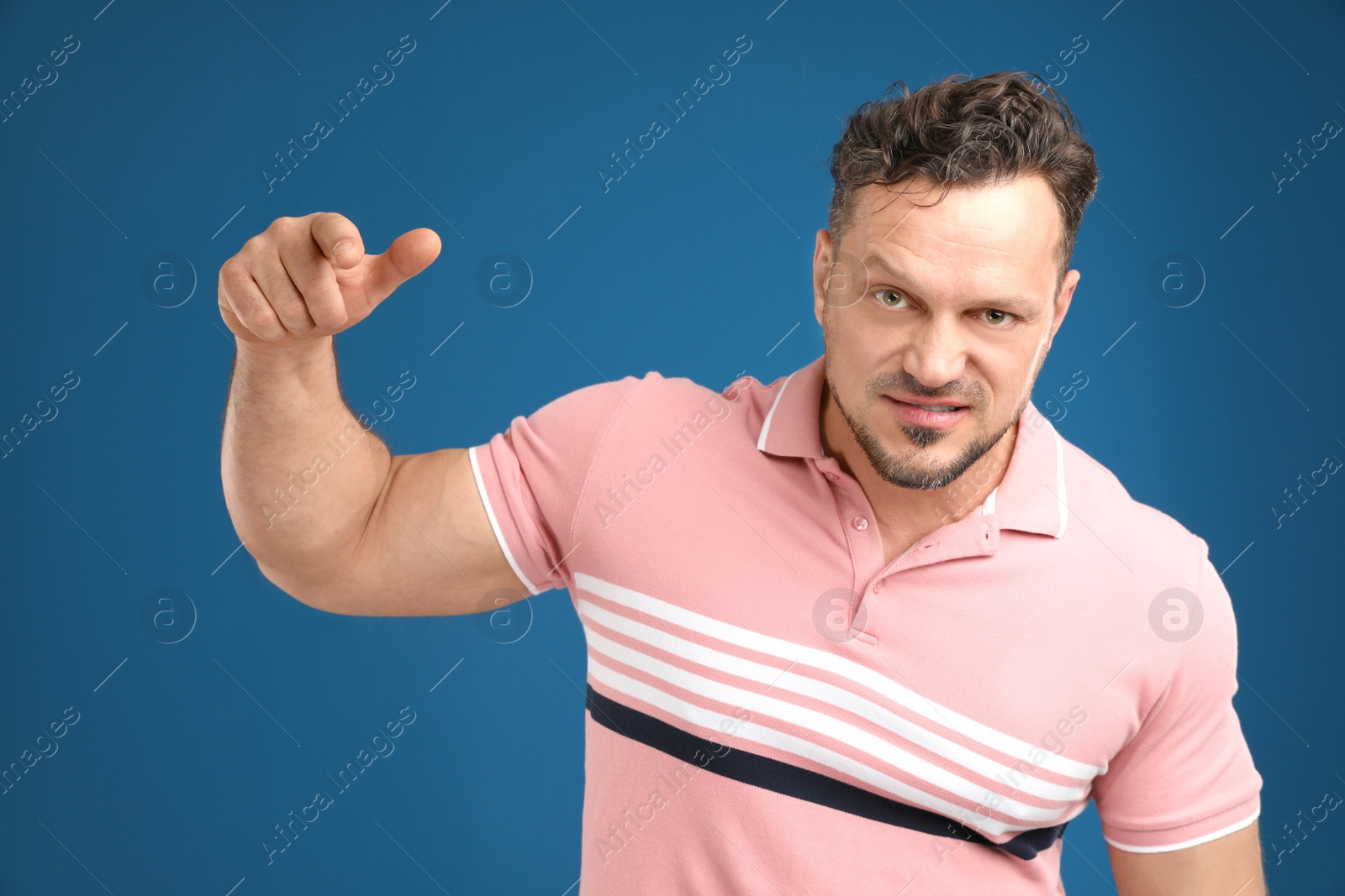 Photo of Portrait of handsome man on dark blue background