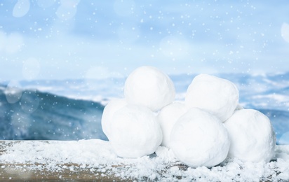 Snowballs against blurred mountains. Winter outdoor activity