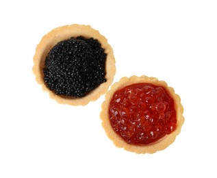 Photo of Delicious tartlets with red and black caviar on white background, top view