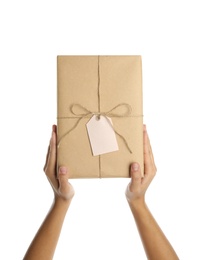 Photo of Woman holding parcel wrapped in kraft paper on white background, closeup