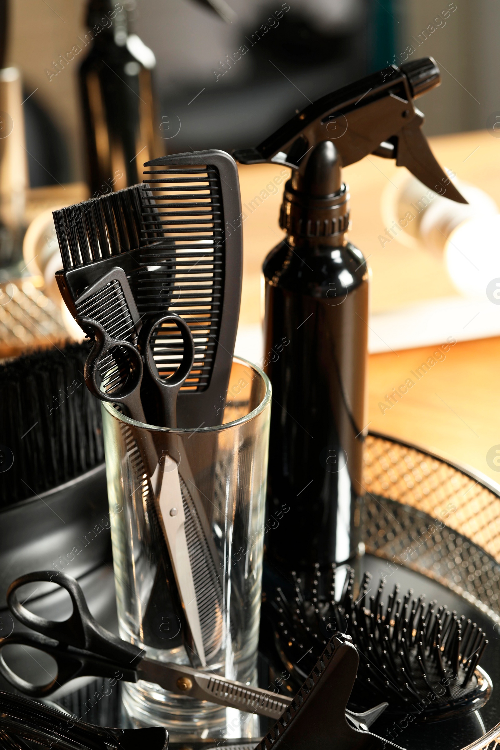 Photo of Set of hairdresser tools in salon, closeup