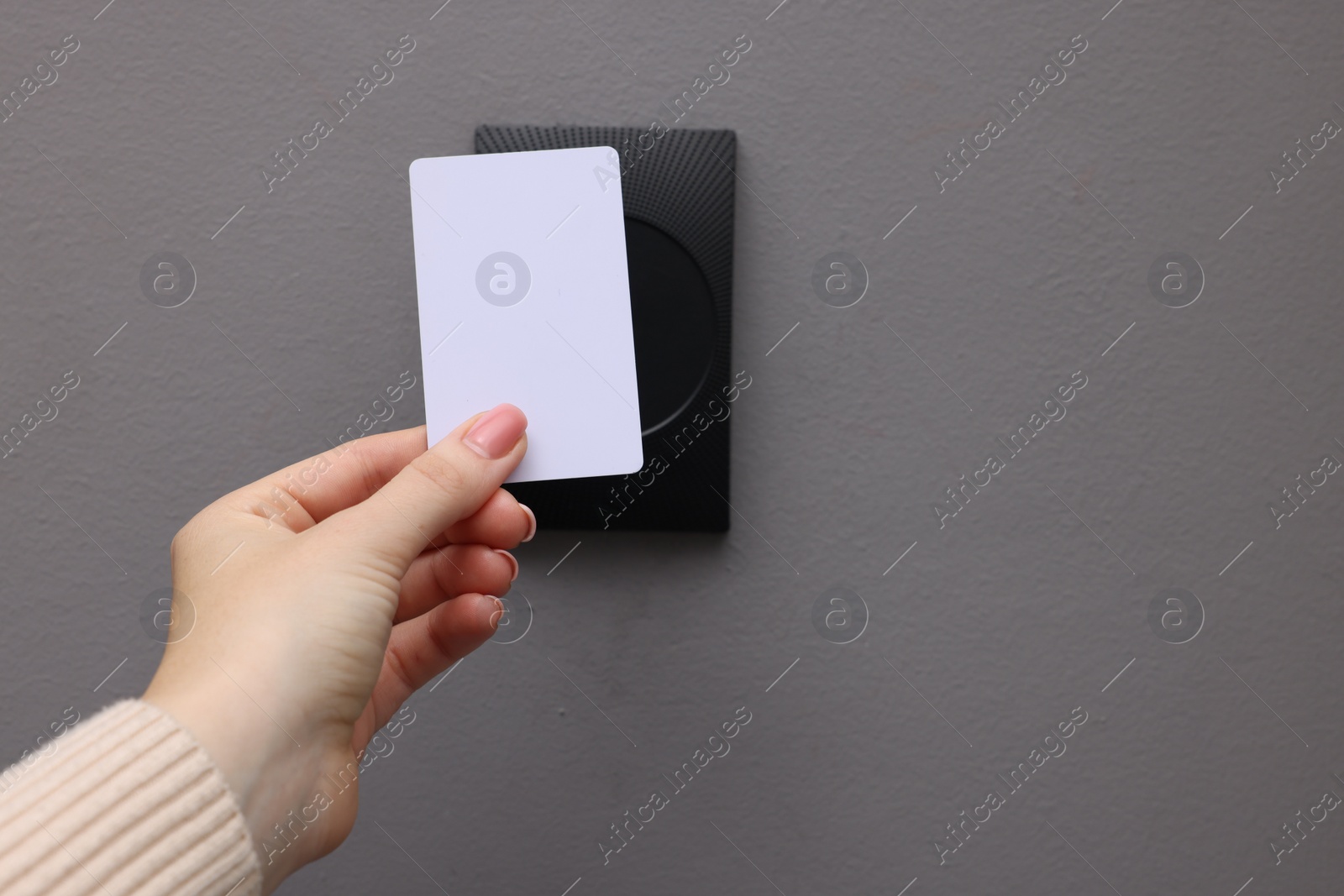 Photo of Woman opening magnetic door lock with key card, closeup and space for text. Home security