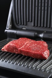 Photo of Cooking fresh beef cut on electric grill