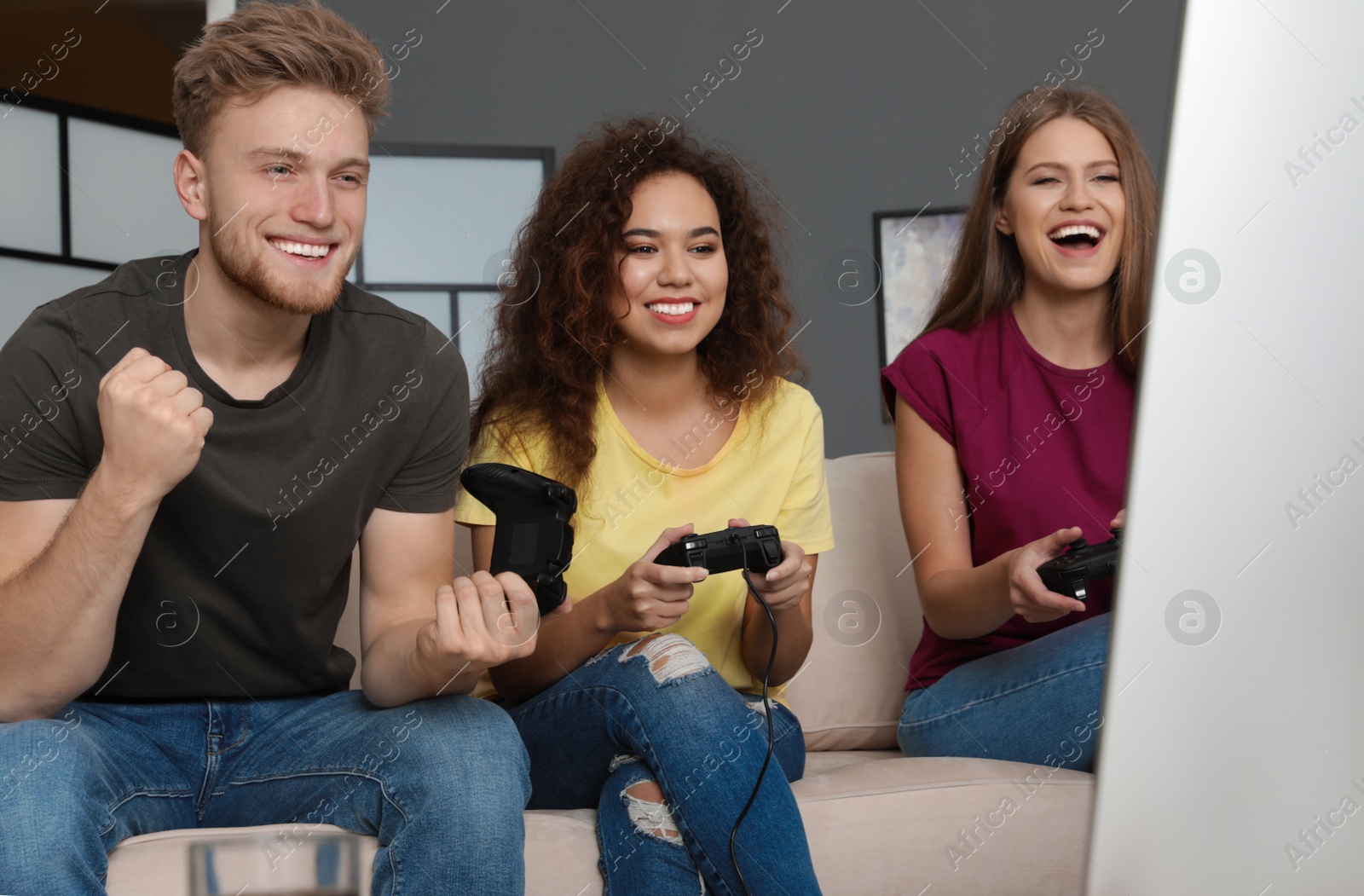 Photo of Emotional friends playing video games at home