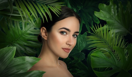 Image of Beautiful young woman and tropical leaves. Spa portrait