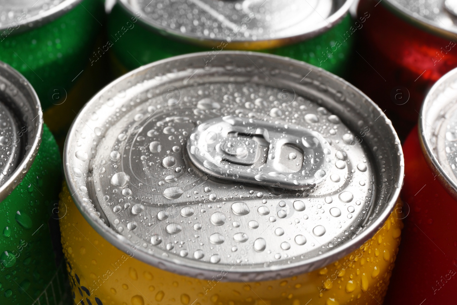 Photo of Energy drinks in wet cans, closeup. Functional beverage