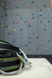 Climbing equipment on white table in gym. Space for text