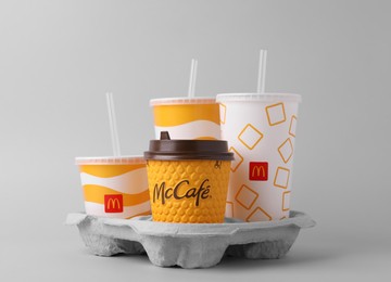 Photo of MYKOLAIV, UKRAINE - AUGUST 12, 2021: Cold and hot McDonald's drinks on light background