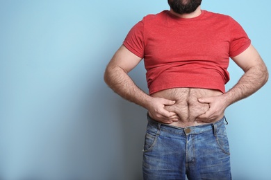 Photo of Overweight man on color background