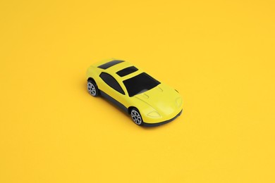 One bright car on yellow background. Children`s toy