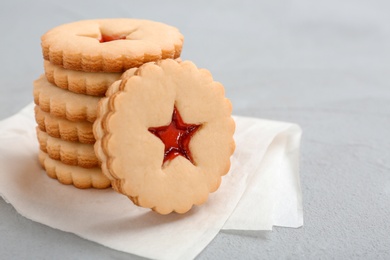 Photo of Traditional Christmas Linzer cookies with sweet jam on table