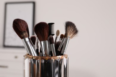 Photo of Set of professional brushes indoors, closeup. Space for text