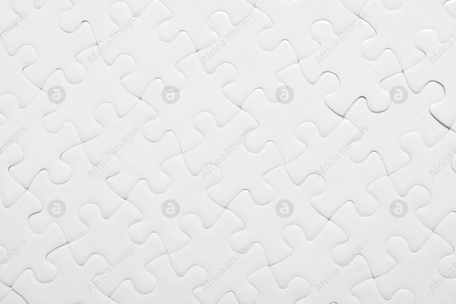 Photo of Blank white puzzle as background, top view