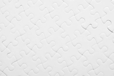 Photo of Blank white puzzle as background, top view