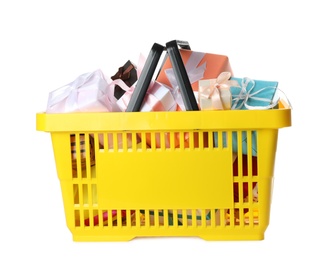 Photo of Shopping basket full of gift boxes on white background