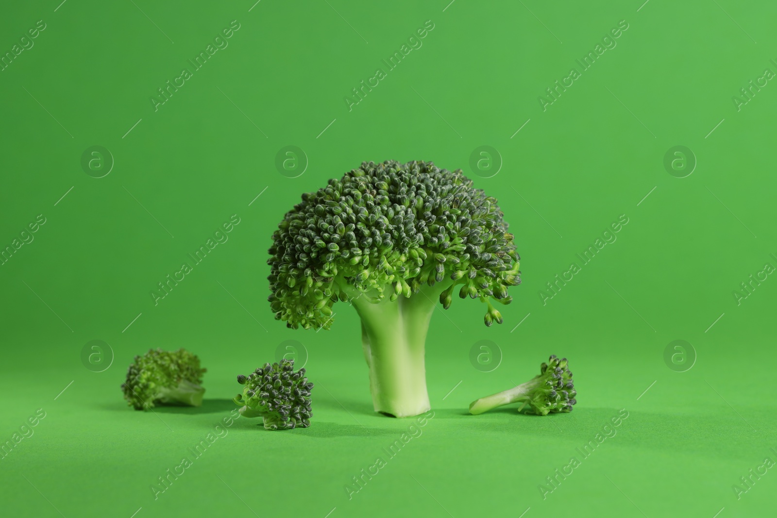 Photo of Fresh raw broccoli on light green background