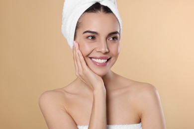 Photo of Young woman in towels on beige background. Spa treatment