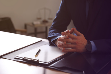 Male lawyer at table in office, closeup