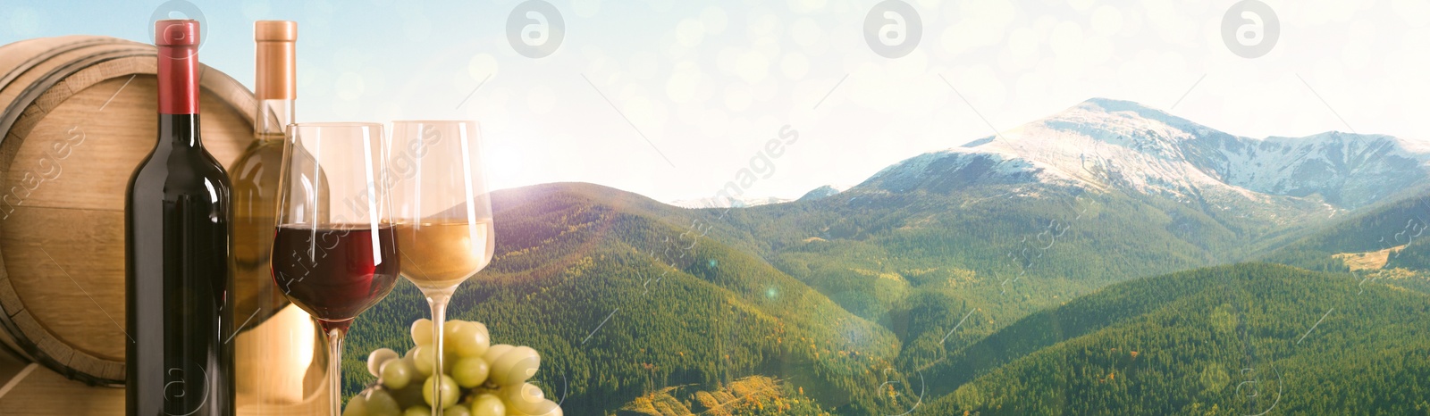 Image of Tasty wine, grapes and barrel against beautiful mountain landscape, space for text. Banner design