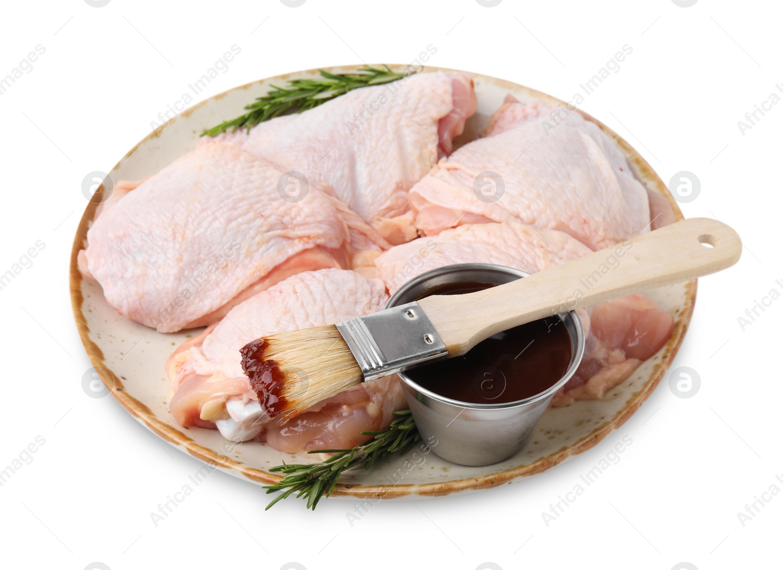 Photo of Plate with marinade, basting brush, raw chicken and rosemary isolated on white