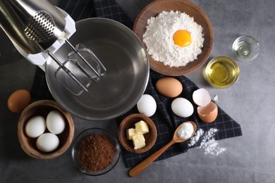 Stand mixer and different ingredients for dough on grey table, flat lay