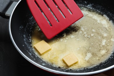 Melting butter in frying pan, closeup view