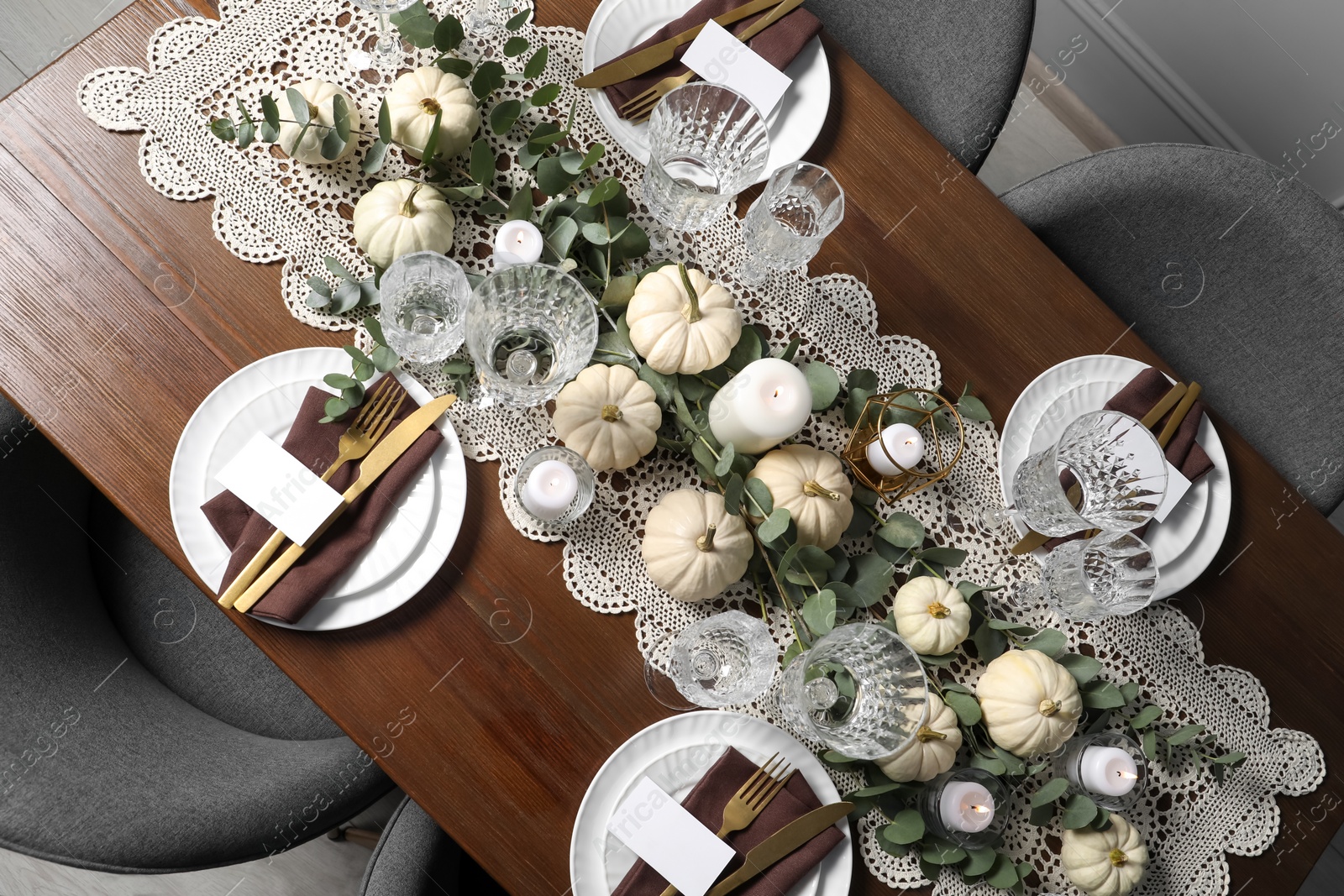 Photo of Beautiful autumn table setting. Plates, cutlery, glasses, blank cards and floral decor, flat lay