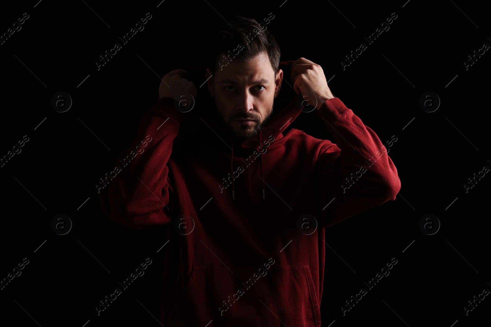 Photo of Portrait of handsome bearded man on black background