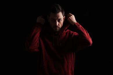 Photo of Portrait of handsome bearded man on black background