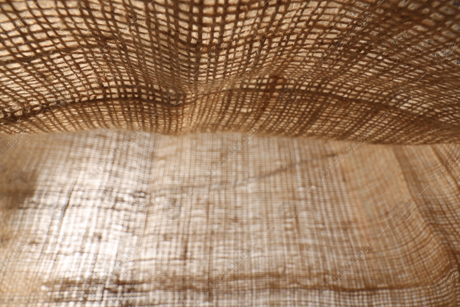 Photo of Texture of natural burlap fabric as background, closeup