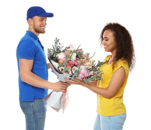 Photo of African-American woman receiving flower bouquet from delivery man isolated on white