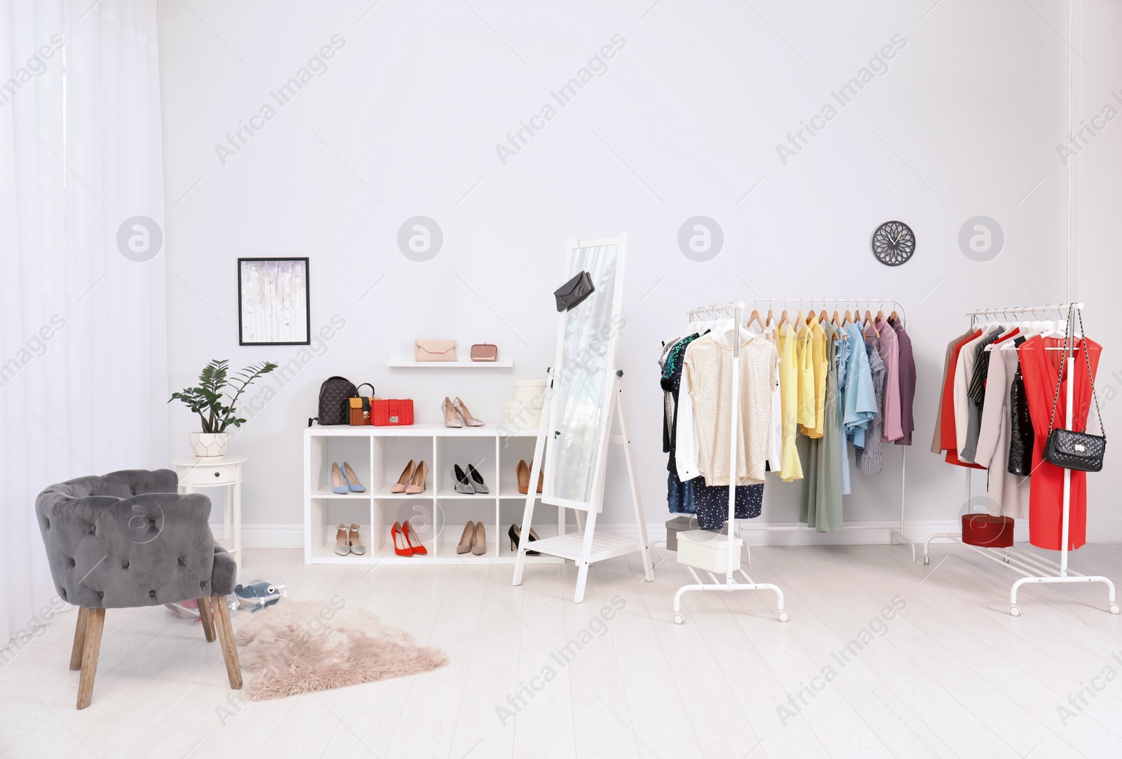 Photo of Light room interior with stylish clothes and shoes