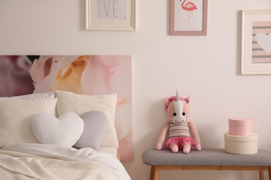 Photo of Modern teenager's room interior with comfortable bed and toy