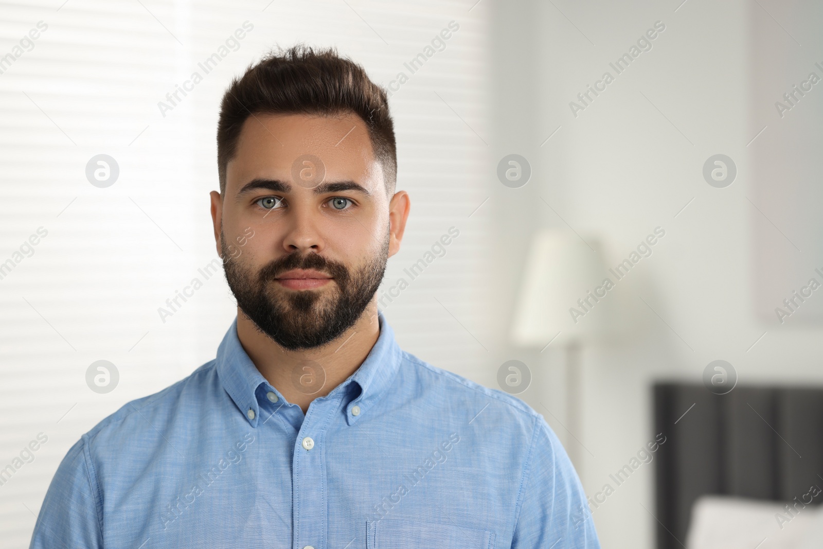 Photo of Portrait of handsome young man indoors. Space for text