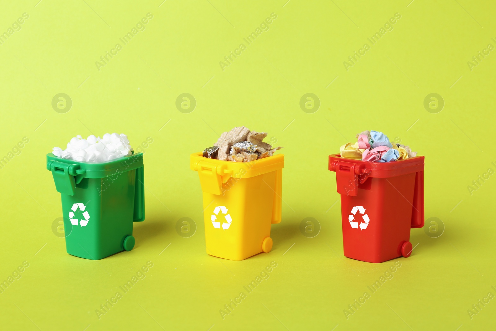 Photo of Trash bins and different garbage on color background. Waste recycling concept