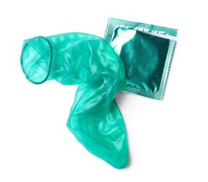 Unrolled turquoise condom and package on white background, top view. Safe sex
