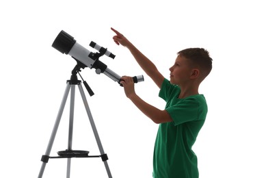 Photo of Cute little boy with telescope pointing at something on white background