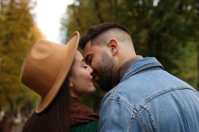 Happy young couple spending time together in autumn park