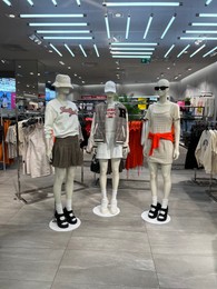 WARSAW, POLAND - JULY 17, 2022: Fashion store interior with women clothes on mannequins in shopping mall